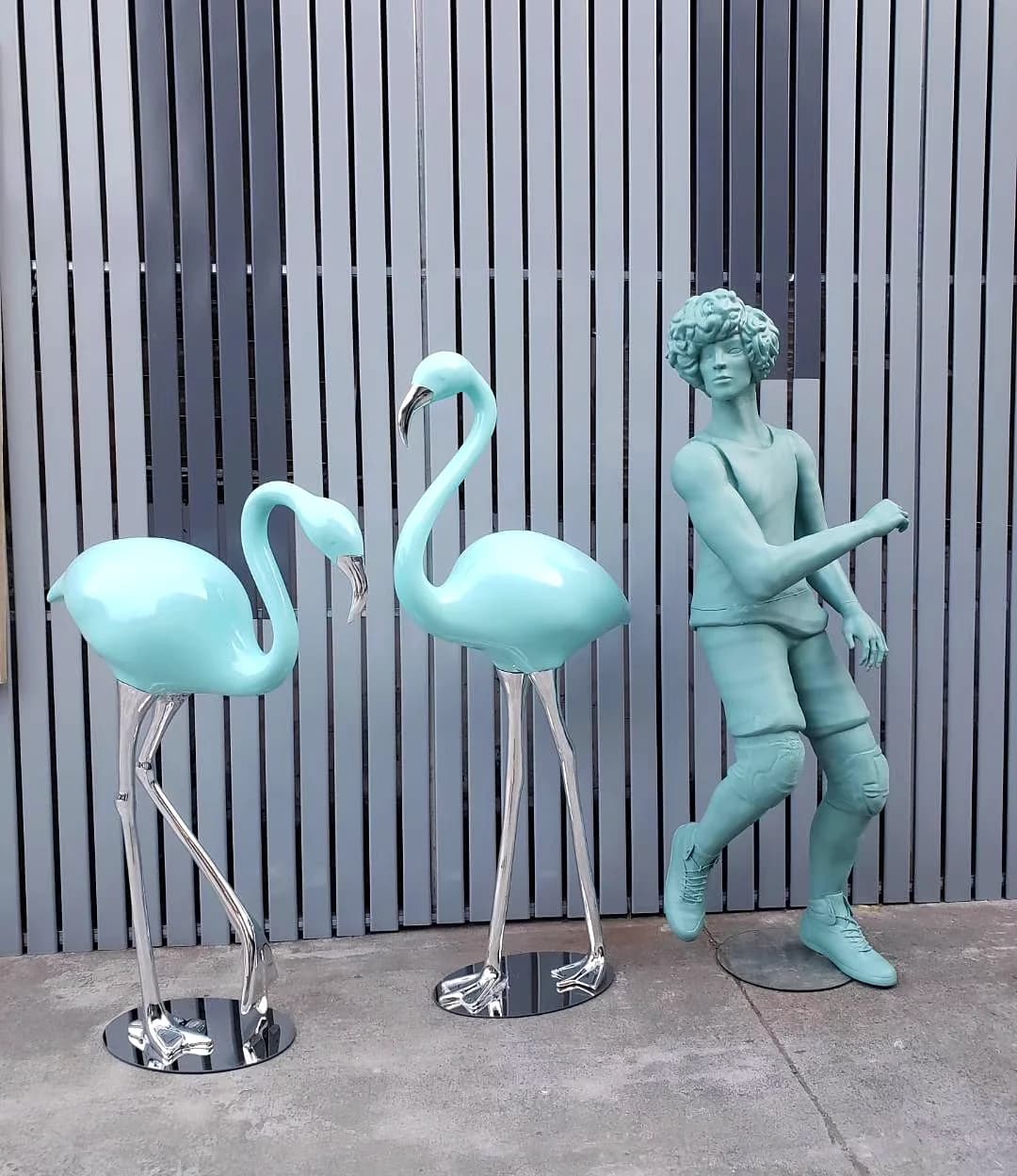 Turquoise flamingo and human figure sculptures at the YAVIS workshop